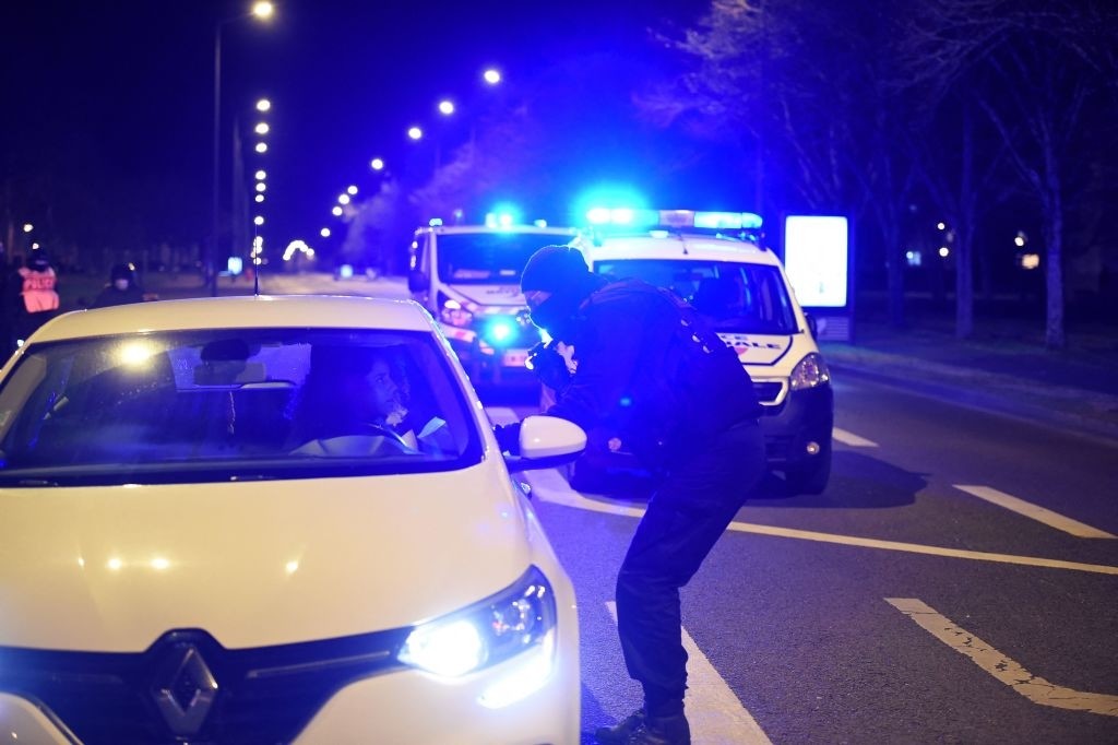 A police officer controls a car during a traffic stop after a night of riots in the north of Blois, center France on March 17, 2021. - The clashes started with a refusal to obey during a control by the Anti-Crime Brigade (Bac) in the northern districts of the city in the night of March 16, 2021. (Photo by GUILLAUME SOUVANT / AFP) (Photo by GUILLAUME SOUVANT/AFP via Getty Images)