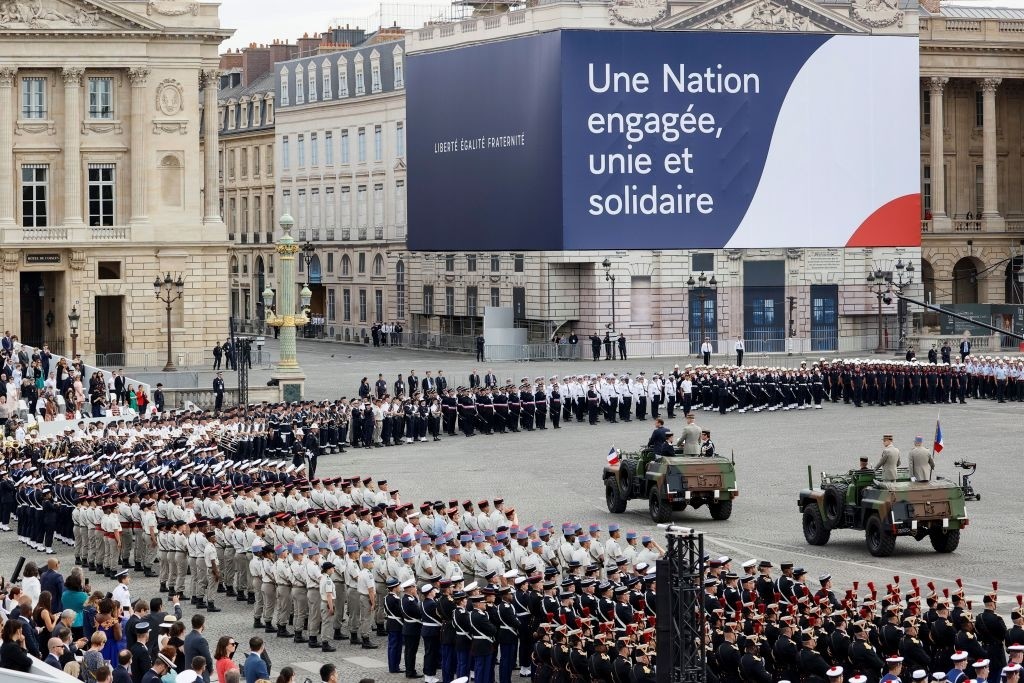 French President Emmanuel Macron arrives with Chief of the Defence Staff General Francois Lecointre prior to the annual Bastille Day military ceremony on the Place de la Concorde in Paris, on July 14, 2020. - France holds a reduced version of its traditional Bastille Day parade this year due to safety measures over the COVID-19 (novel coronavirus) pandemic, and with the country's national day celebrations including a homage to health workers and others fighting the outbreak. (Photo by Thomas SAMSON / AFP) (Photo by THOMAS SAMSON/AFP via Getty Images)