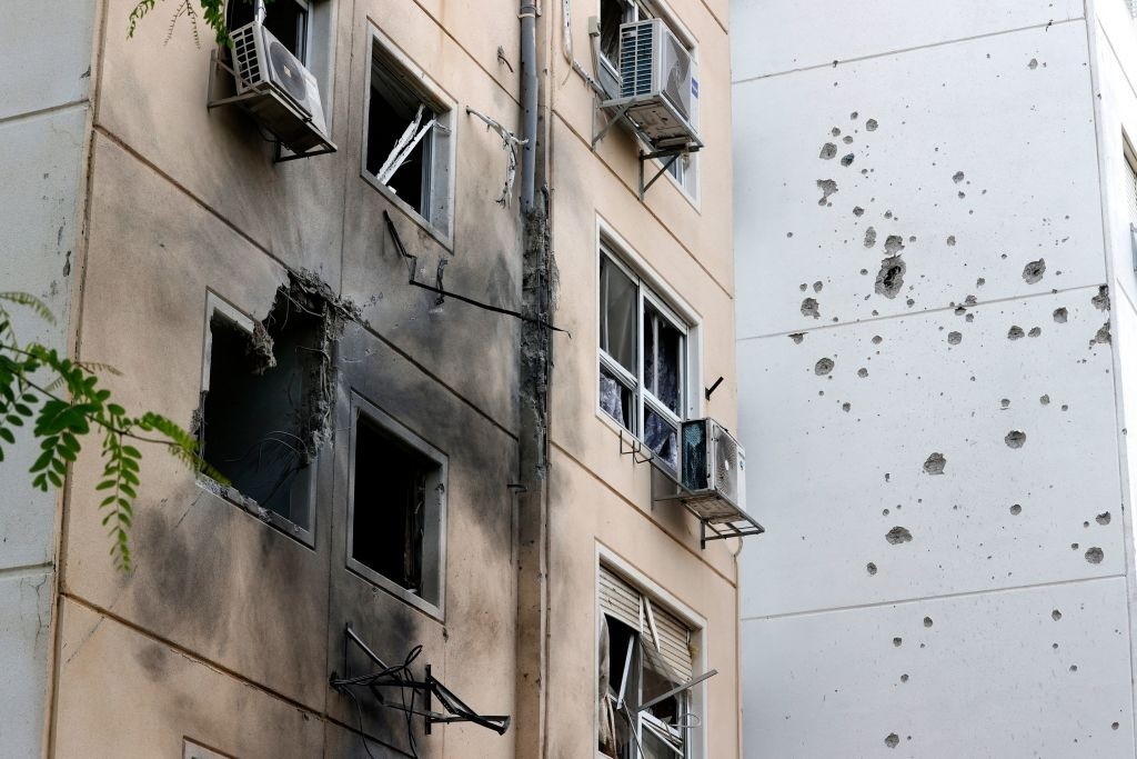 A picture taken early on May 11, 2021 shows a damaged building in the southern Israeli city of Ashkelon after rockets were fired by the Hamas movement from the Gaza Strip towards Israel overnight amid spiralling violence. - Israel's army said that it had hit 130 "military targets" in Gaza in retaliatory strikes after Palestinian militant groups launched a flurry of rockets towards Israel, as violence spiralled since confrontations with Israeli police in Jerusalem's flashpoint Al-Aqsa mosque compound wounded hundreds of Palestinians. (Photo by JACK GUEZ / AFP) (Photo by JACK GUEZ/AFP via Getty Images)