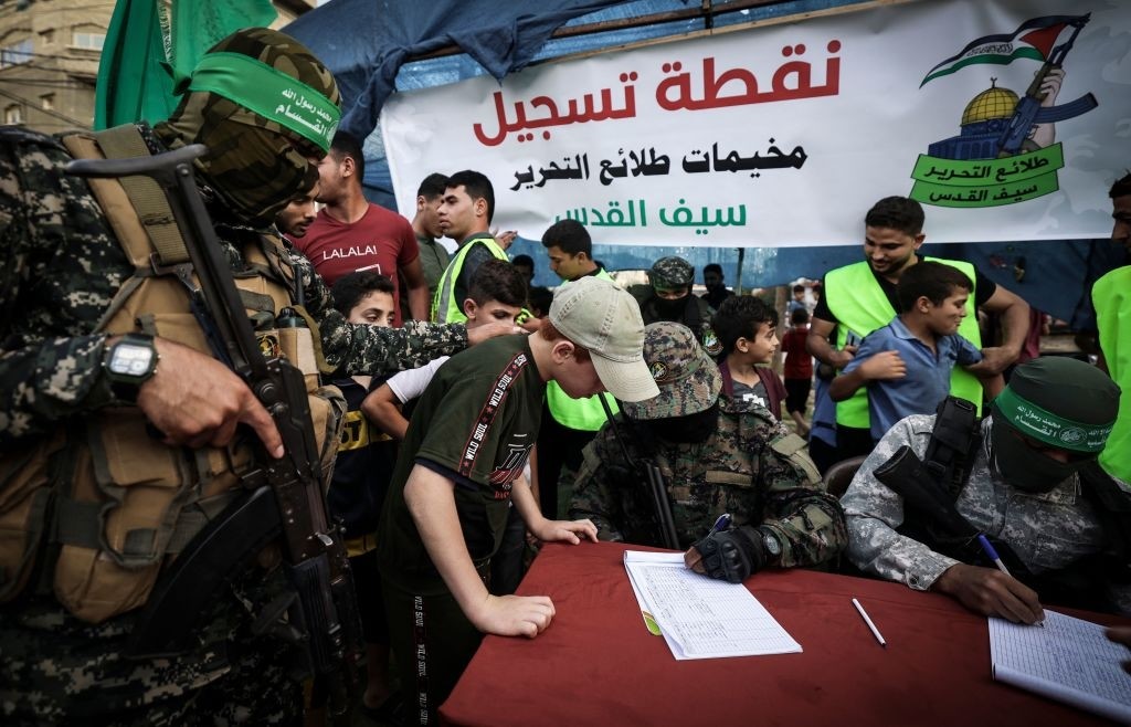 Palestinian boys register in a summer camp organised by the Ezz-Al Din Al-Qassam Brigades in Gaza City on June 14, 2021. (Photo by MAHMUD HAMS / AFP) (Photo by MAHMUD HAMS/AFP via Getty Images)