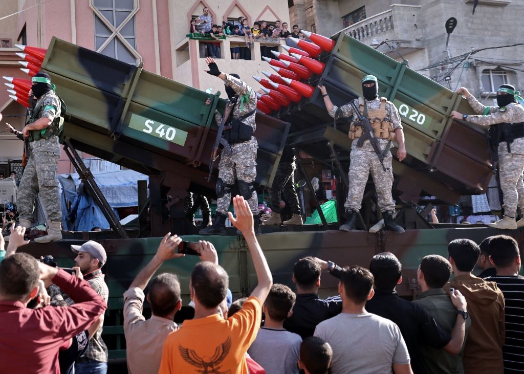 Members of the Ezz-Al Din Al-Qassam Brigades, the armed wing of the Palestinian Hamas movement, parade on trucks with rockets in a street in Khan Yunis, in the southern Gaza Strip on May 27, 2021. - A ceasefire was reached late last week after 11 days of heavy Israeli bombing of Gaza and rocket fire from the Hamas-run Palestinian coastal enclave into Israel. (Photo by THOMAS COEX / AFP) (Photo by THOMAS COEX/AFP via Getty Images)