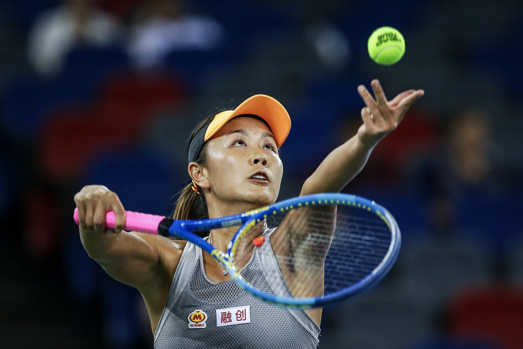 WUHAN, CHINA - SEPTEMBER 23:  Shuai Peng of China severs a shot during the match against Garbine Muguruza of Spain on Day 2 of 2019 Dongfeng Motor Wuhan Open at Optics Valley International Tennis Center on September 23, 2019 in Wuhan, China.  (Photo by Wang He/Getty Images)