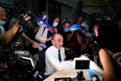 TOPSHOT - French far-right media pundit Eric Zemmour signs autographs during the promotion launch event for his new book "France hasn't said its last word" (La France na pas dit son dernier mot) in Toulon, southern France, on September 17, 2021. - French far-right pundit Eric Zemmour is inching closer to announcing a run for the presidency, a move that would create fresh uncertainty around France's 2022 election race. (Photo by Nicolas TUCAT / AFP) (Photo by NICOLAS TUCAT/AFP via Getty Images)