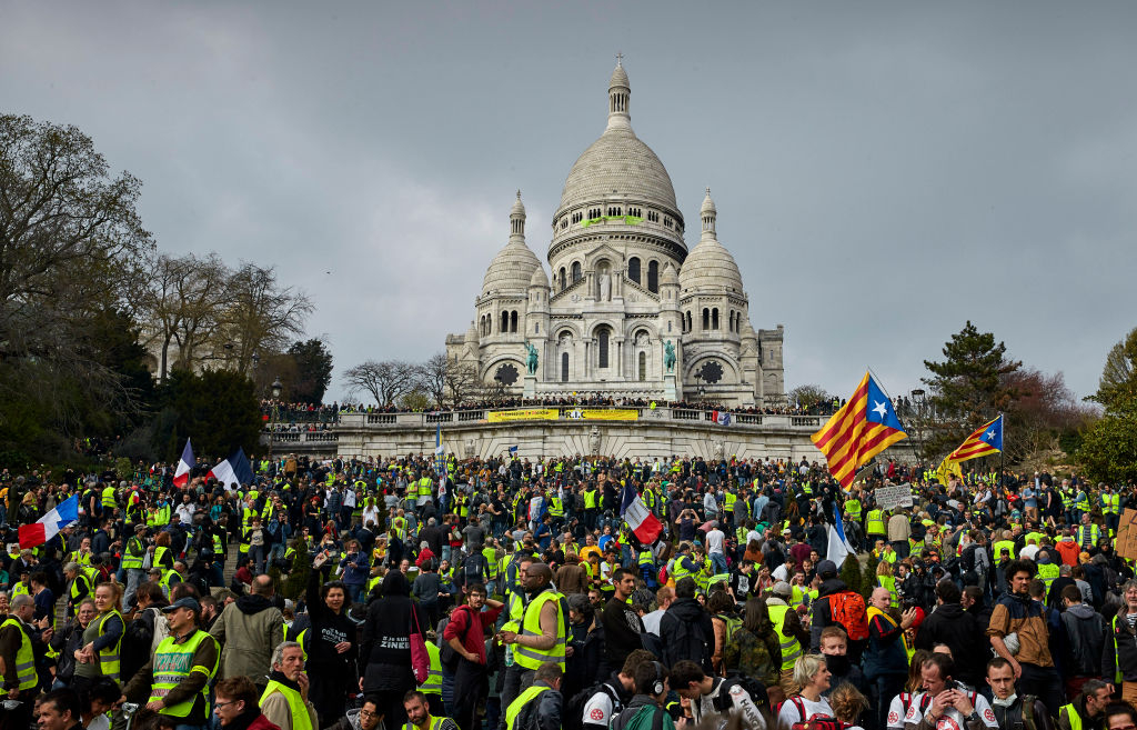 PARIS, FRANCE - MARCH 23: Gilets Jaunes or 'Yellow Vest' occupy the steps leading to the Baslique du Sacre Coeur during Act 19 of protests on March 23, 2019 in Paris, France. After last week’s violent protests on the Champs-Elysees, the Minister of the Interior Christophe Castaner announced zero tolerance in a bid to avoid a repeat, banning protests on the Champs Elysees and mobilising the Army’s Sentinel anti-terrorist unit to help reinforce the police in an unprecedented mobilisation of the army in France since the Algerian war. (Photo by Kiran Ridley/Getty Images)