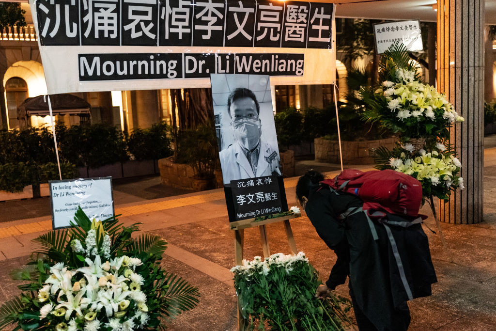 HONG KONG, CHINA - FEBRUARY 07: People attend a vigil to mourn for doctor Li Wenliang on February 7, 2020 in Hong Kong, China. Doctor Li Wenliang was a Chinese ophthalmologist at Wuhan Central Hospital and a whistleblower who warned about the novel coronavirus outbreak but was summoned by police and admonished him for making false comments on the Internet. (Photo by Anthony Kwan/Getty Images)