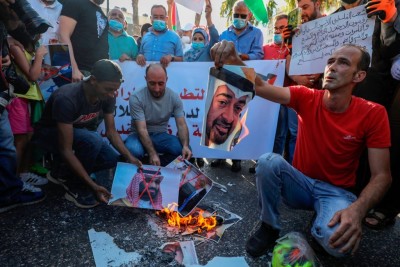 Palestinian protesters burn pictures of Abu Dhabi Crown Prince Sheikh Mohammed bin Zayed Al Nahyan (top) and Saudi Crown Prince Mohammed bin Salman, during a demonstration against the Emirati-Israeli agreement, in Ramallah in the occupied West Bank, on August 15, 2020. (Photo by ABBAS MOMANI / AFP) (Photo by ABBAS MOMANI/AFP via Getty Images)