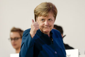 HAMBURG, GERMANY - DECEMBER 7: German Chancellor and leader of the German Christian Democrats (CDU) Angela Merkel  waves to the delegates after their speach at the 31. Federal Party Congress  on December 7, 2018 in Hamburg, Germany. Merkel will step down as leader of the party following an 18-year reign. CDU delegates will elect a successor from a choice of three candidates: Annegret Kramp-Kannrenbauer, whom Merkel favors, Friedrich Merz and Jens Spahn. (Photo by Carsten Koall/Getty Images)